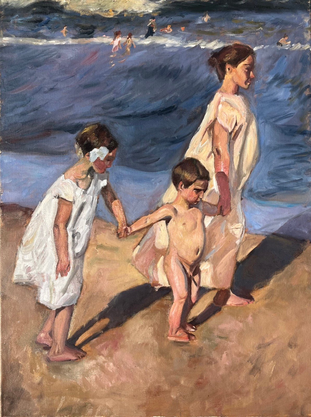 Beach scene of a woman in a white dress leading two children by the hand across wet sand at the water's edge, bathers in the surf beyond