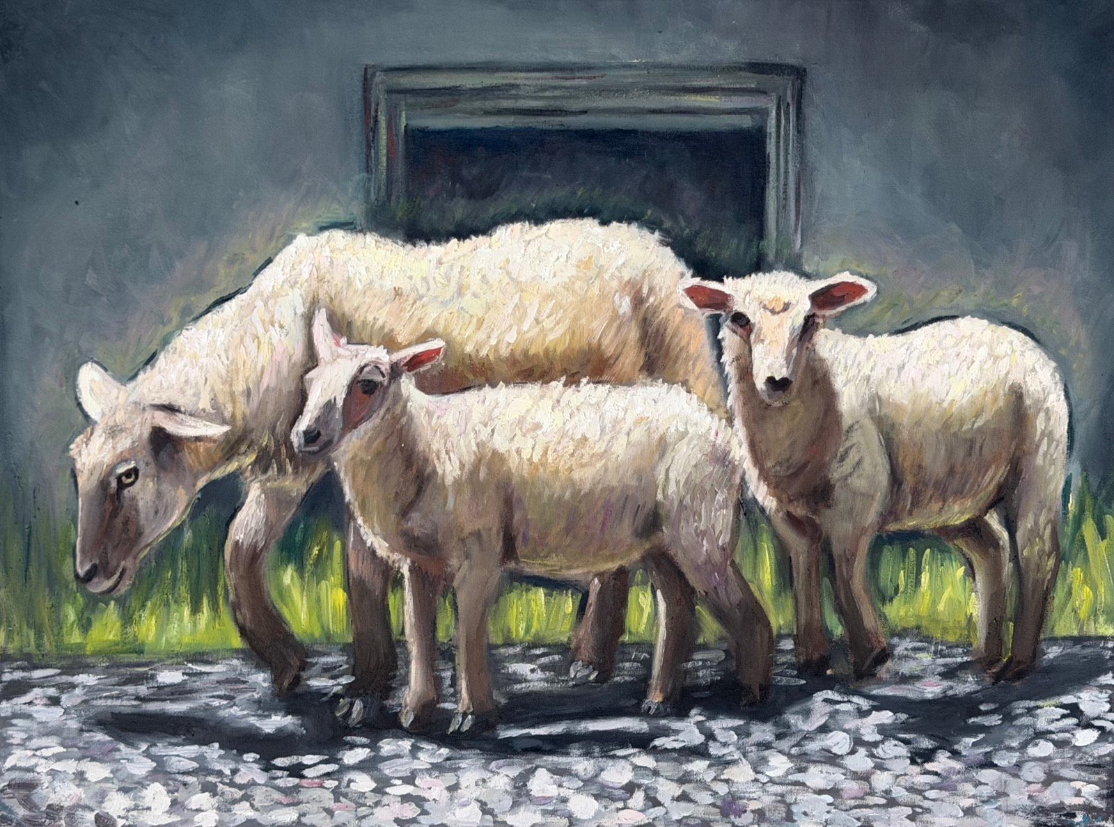 Three white sheep standing on pale cobblestones before a dark grey wall hung with a shadowed picture frame